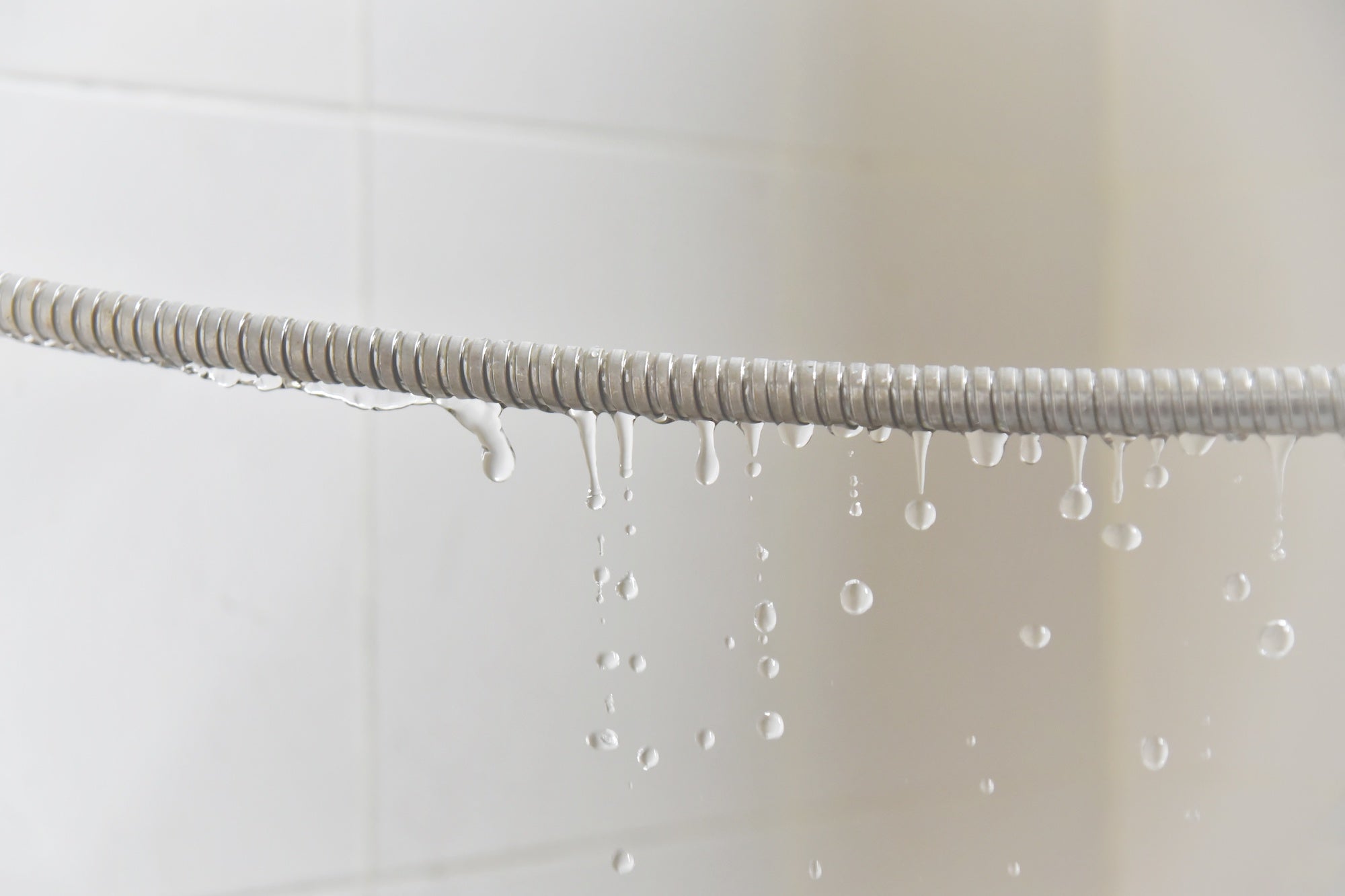 310962341 Image showing a leaking shower hose pipe