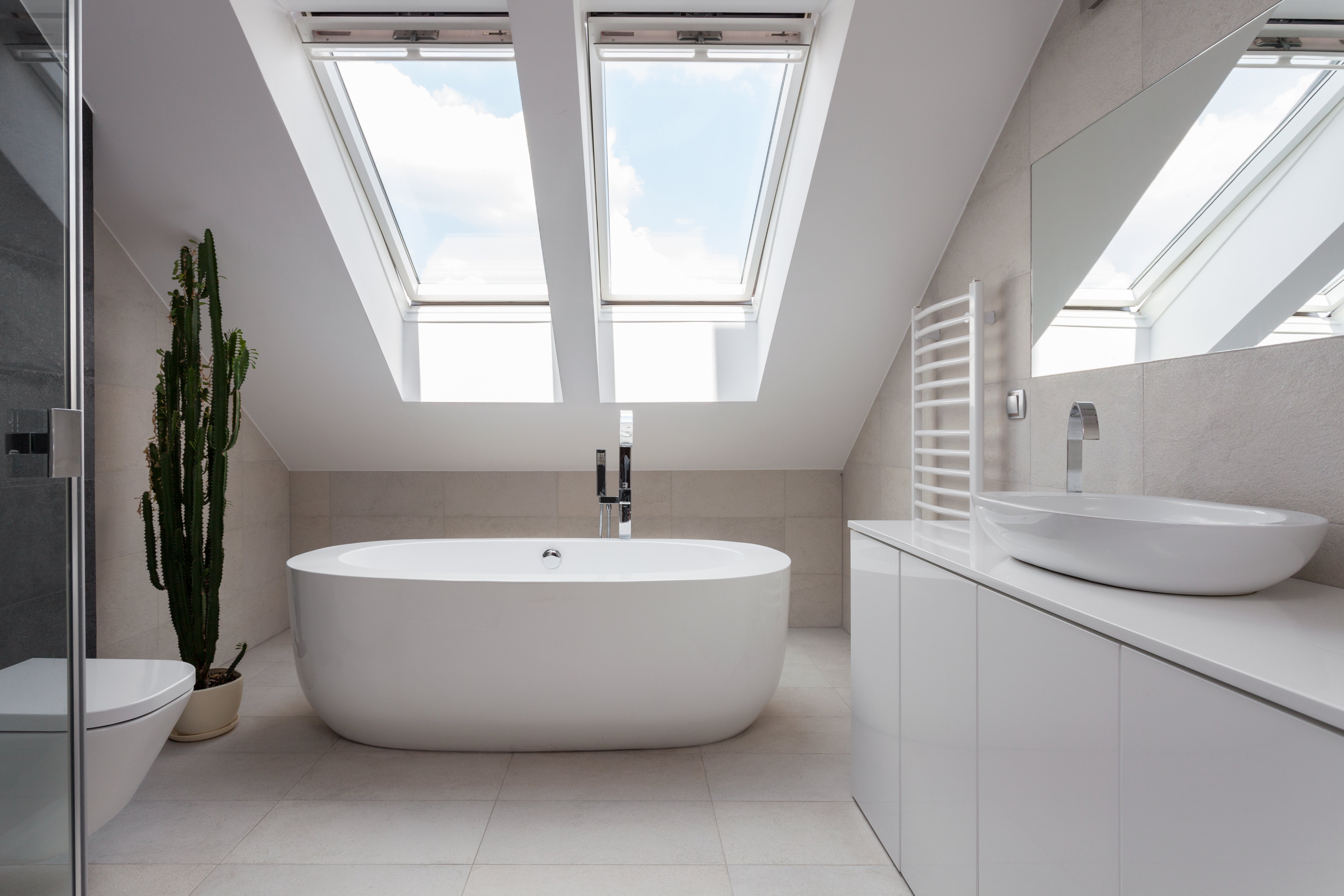 86238025 Luxury bathroom with skylights and large white ceramic standalone bath